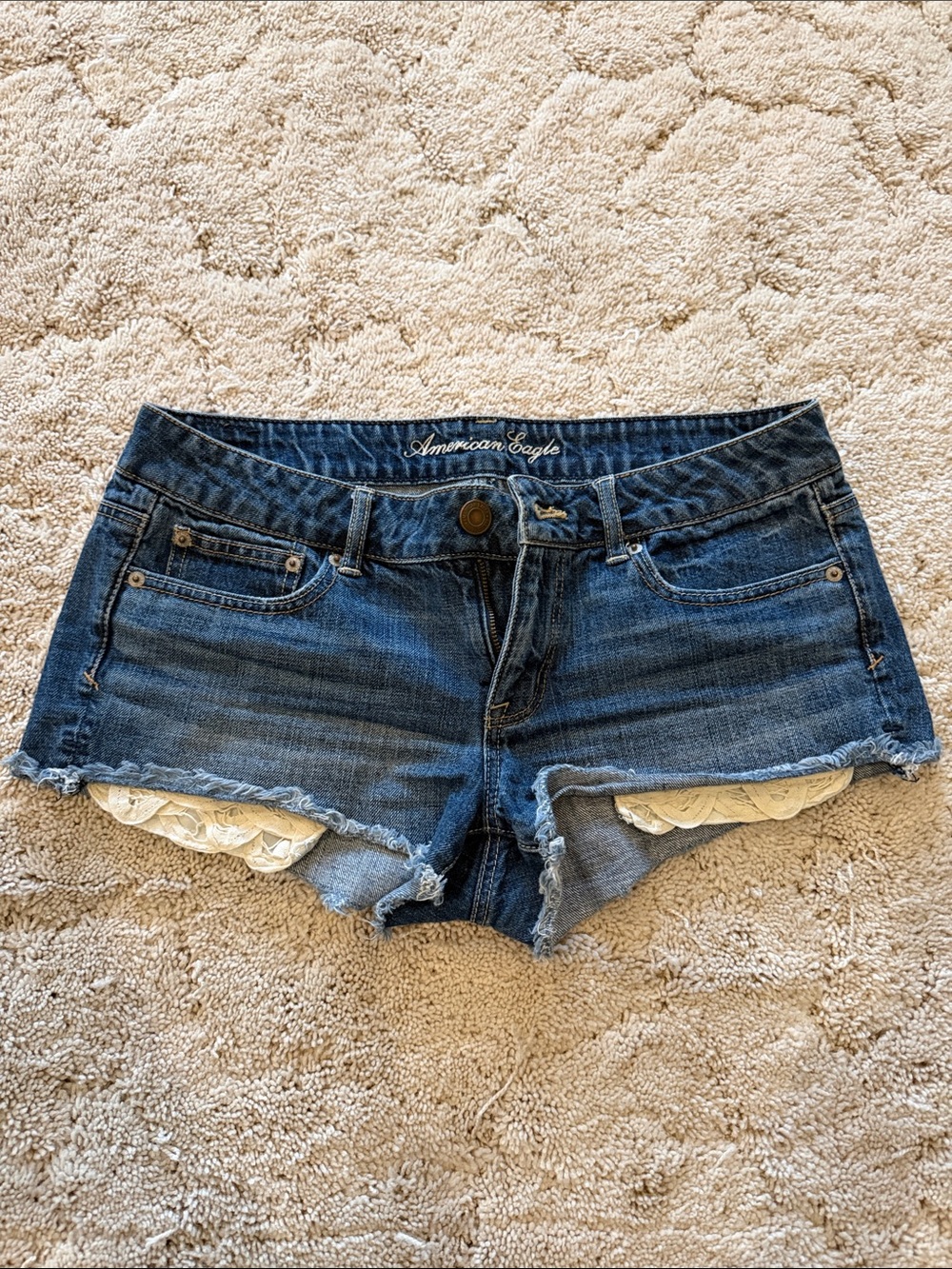 American Eagle Outfitters Blue Denim Cutoff Shorts with White Lace Pockets